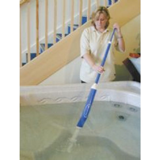 Woman cleaning her spa with the spa/pool vacuum